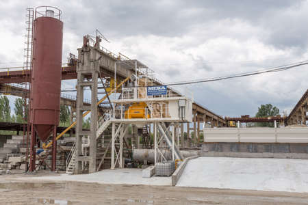 KIEV, UKRAINE - MAY 20, 2016: Old factory for concrete production. The staff and machines of the old workshop of concrete production. Technological processes of concrete productionのeditorial素材