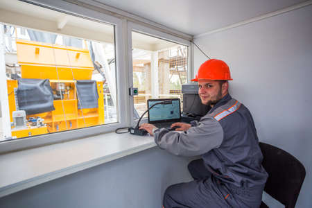 KIEV, UKRAINE - MAY 20, 2016: Old factory for concrete production. The staff and machines of the old workshop of concrete production. Technological processes of concrete productionのeditorial素材