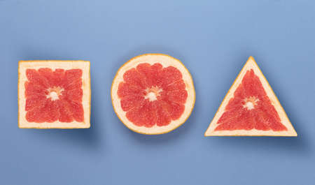 Various forms of grapefruit, on blue texture. perfect concept of fruitsの写真素材