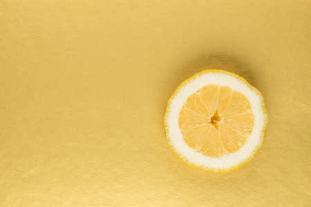 Yellow lemon on a gold background. It has a rich and beautiful viewの写真素材