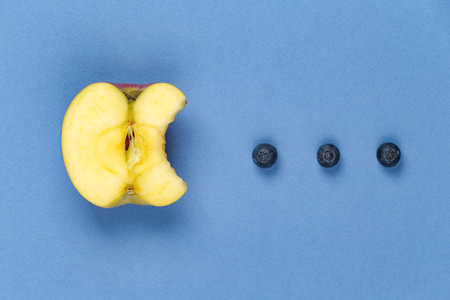 Apple hunts blueberries, like in the old school gameの写真素材