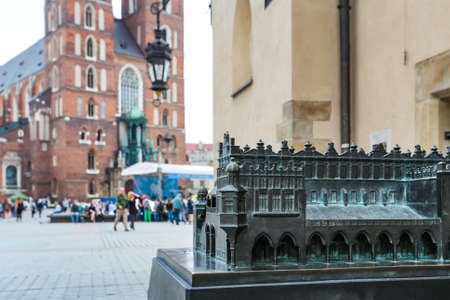 Krakow, Poland- May 25, 2016: Small copy of Church of Our Lady Assumed into Heaven. Is a Brick Gothic church re-built in the 14th century. With tourists on squareのeditorial素材