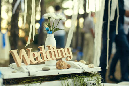 Beautiful wedding decoration in rustic style in the woods. Wooden word wedding.の写真素材