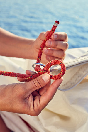 User knitting knots. Bowline knot. Process of tying Bowline process is a top view on the sail.