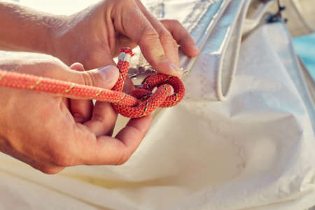 User knitting knots. Bowline knot. Process of tying Bowline process is a top view on the sail.の写真素材