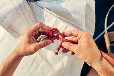 User knitting knots. Bowline knot. Process of tying Bowline process is a top view on the sail.の写真素材