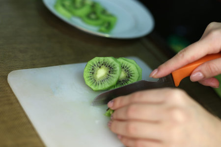 Kiwi cut with a knife on a cutting board