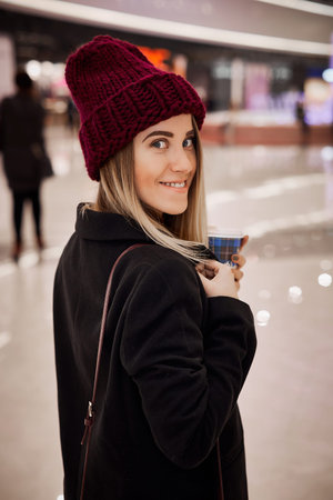 Girl drinks coffee and relaxing after shopping in the mallの写真素材