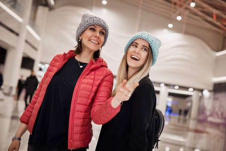 Two girls are happy becouse they have new purchases in shopping centerの写真素材