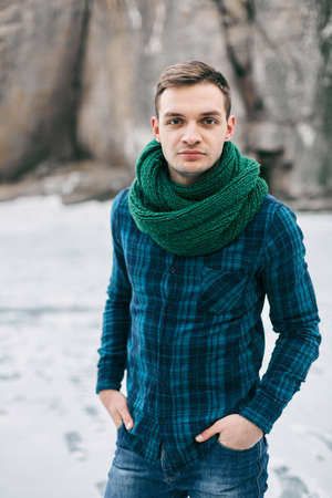 The guy in the checkered shirt in the mountains cold weatherの写真素材