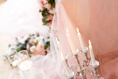 Candles near the wedding table in ivory colorsの写真素材