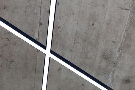 Ceiling in the loft style. Grey ceiling with fashionable energy-efficient line lightingの写真素材