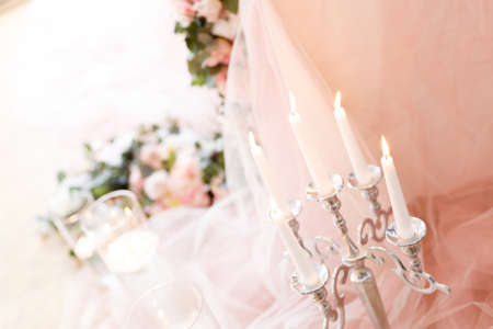 Candles near the wedding table in ivory colorsの写真素材