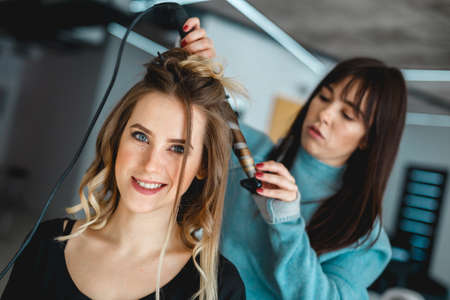 Kyiv, Ukraine - March 3, 2017: A girl in a beauty salon makes a hairstyle for a wedding.のeditorial素材