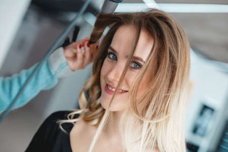 Kyiv, Ukraine - March 3, 2017: Portrait of a young woman in a beauty salon during a hairdo.のeditorial素材