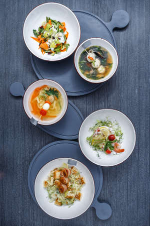 Still life of food, soup of mussels, meat salad on the table. Top view healthy and delicious foodの写真素材
