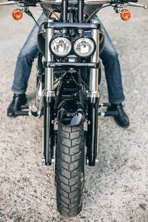 Top view of a motorcycle headlight. Man seat on the motorcycle.の写真素材