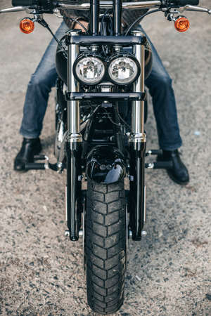 Motorcycle headlight and man wearing jeans on motorbike. Copyspace for your individual text.の写真素材