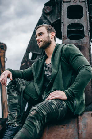 Portrait fashion man wearing clothes khaki colors in urban style. Outdoor summer fashion portrait of beautiful young man posing. Urban fashion.の写真素材
