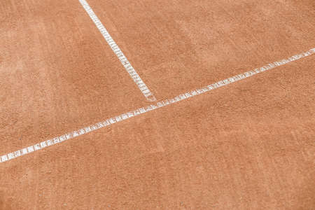 Orange tennis court. White lines on a brown field for a game.の写真素材