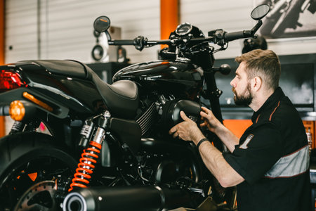 Professional mechanic change the air filter in the motorcycle. Handsome young man repairing...