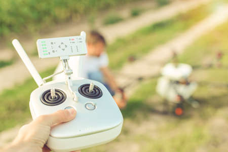 Control panel of the drone against the background of a large Octocopter with an engineer.の写真素材
