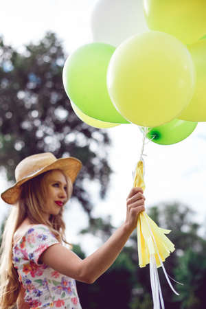 Happy young woman with colorful latex balloons, outdoor. summer holidays, celebration and lifestyle conceptの写真素材