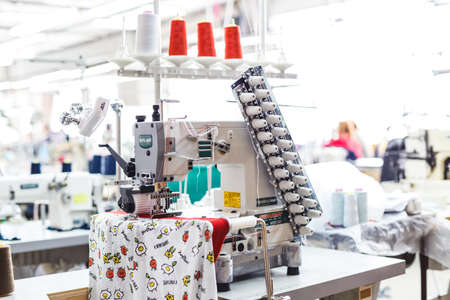 Fabric industry machinery production line. Industrial sewing machine close up.の写真素材