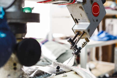 Overlock sewing machine - view on working area and machine front with needle - foreground blanked ot blurry.の写真素材