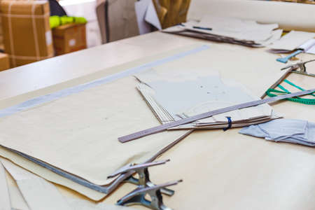 Still life photo of a clothes pattern template with ruler, tape measure on table. Sewing and tailoring tools and accesories.の写真素材