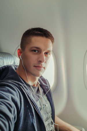 Man in the airplain near window