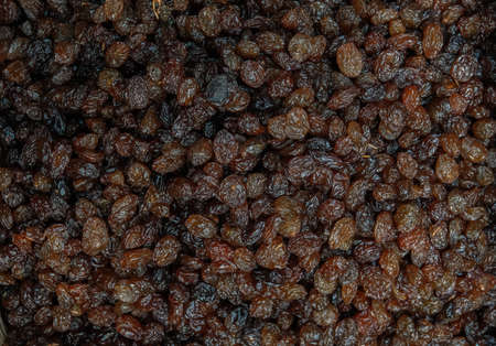 Background of lined dark raisins. Top view of the oriental treats. Fruit texture.の写真素材