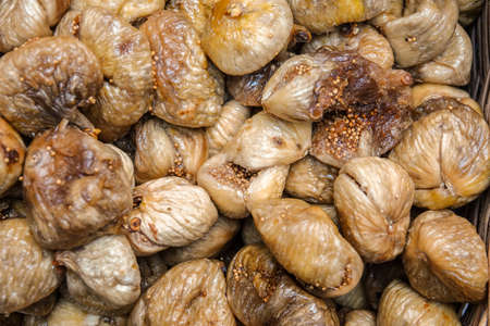 Close up top view dried dried figs. Background of oriental treats texture.の写真素材