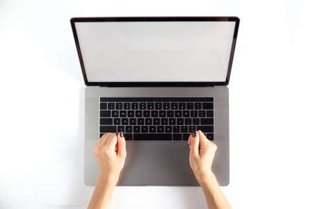 Lap top topview with hands on white background. Mockup developing tool.の写真素材