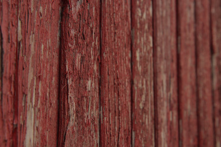 Old red wooden wall texture background with peeling paintの写真素材