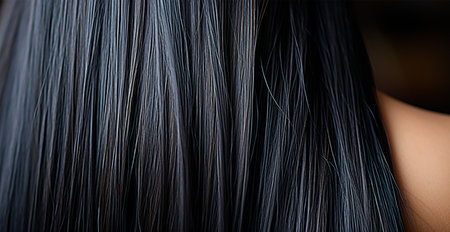 Black hair close-up as background. Women's long natural dark hair. Girl with wavy shiny curls AI generated imageの写真素材