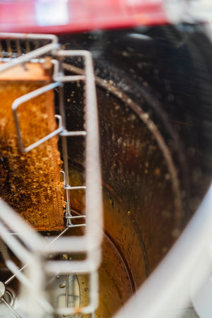 Sugary Honey Trickle Down the Inner Wall of a Metal Barrel of a Honey Extractor for Harvestingの写真素材