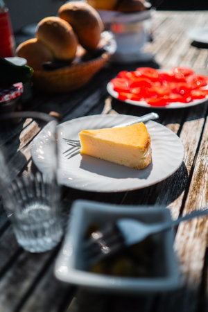 Cheesecake on a Plate Served on a Wooden Table for Breakfastの写真素材