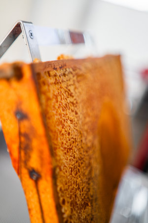 Hive Frame of a Beehive with Filled and Capped Honeycombs Extreme Close Upの写真素材