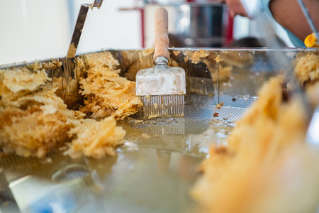 Capping Scratcher in a Metal Decapping Tray with Beewax and Honey During Bee Honey Harvestの写真素材