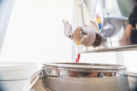 Beekeeping Bee Honey Trickleling Down the Barrel After Extractionの写真素材