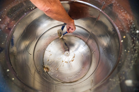 Metal Barrel Cleaning up the Gooey and Viscouse Bee Honey After Centrifugal Extractionの写真素材