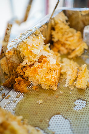 Yellow Beewax Collected in a Tray During Bee Honey Harvestingの写真素材