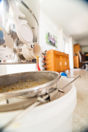 Beekeeping Bee Honey Trickleling Down the Barrel After Centrifugal Extractionの写真素材