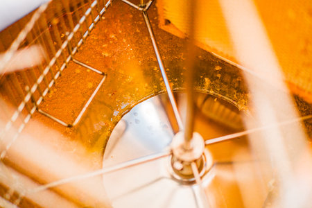 Viscouse Bee Honey at the Bottom of a Centrifugal Extractor Barrel During Beekeeping Harvest Productionの写真素材