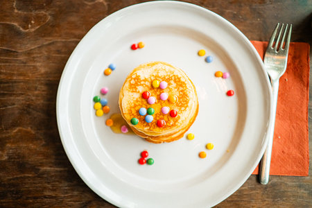Pancakes Topped with Chocolate Lentiles and Honey Top Down View Close Upの写真素材