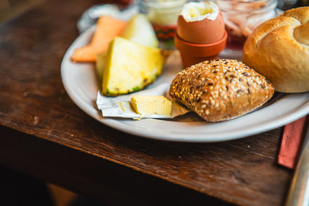 Small Package of Butter on a Breakfast Plate with Bunsの写真素材