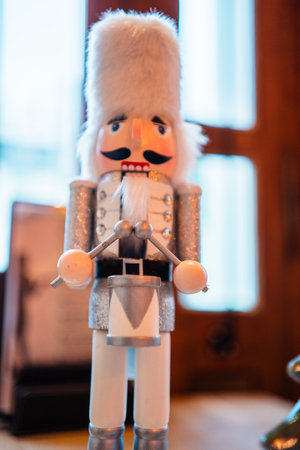 Decorative White Nutcracker With White Fur Bearskin Hat a Silver Costume and Drumsの写真素材