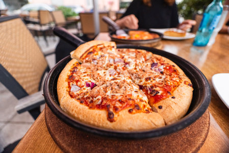 Tuna Pizza in a Frying Pan With Cheese and Onions Freshly Baked From the Oven With a Crusty Brown Crustの写真素材