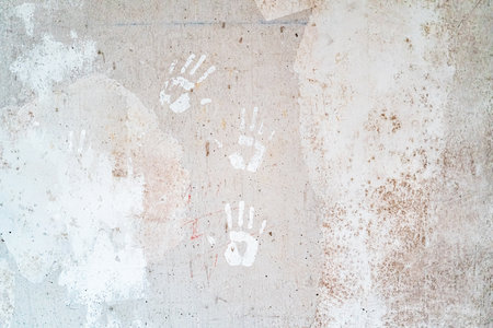 Stone Concrete Wall with White Handprints on the Solid Surfaceの写真素材